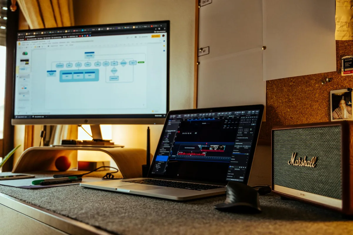 A solo creator at a desk with Canva open on screen, designing a one-page checklist lead magnet — practical workspace setup