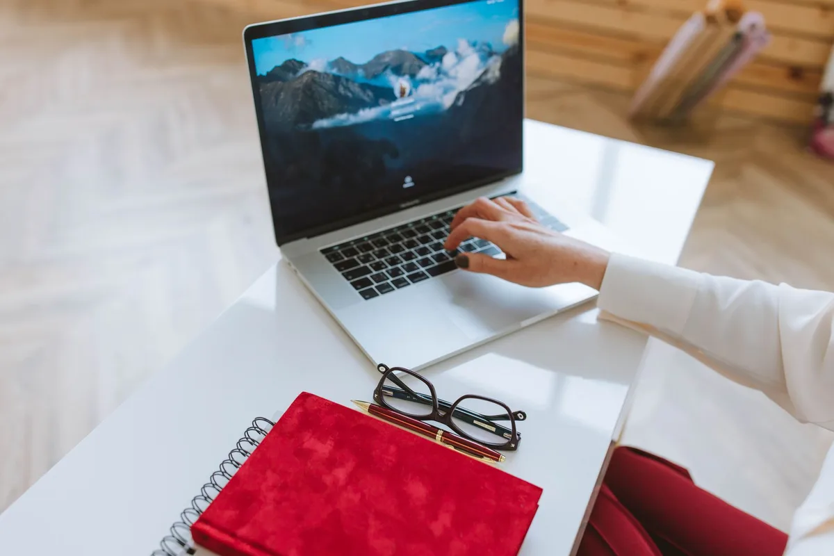 Creator reviewing freebie lead magnet options on a laptop
