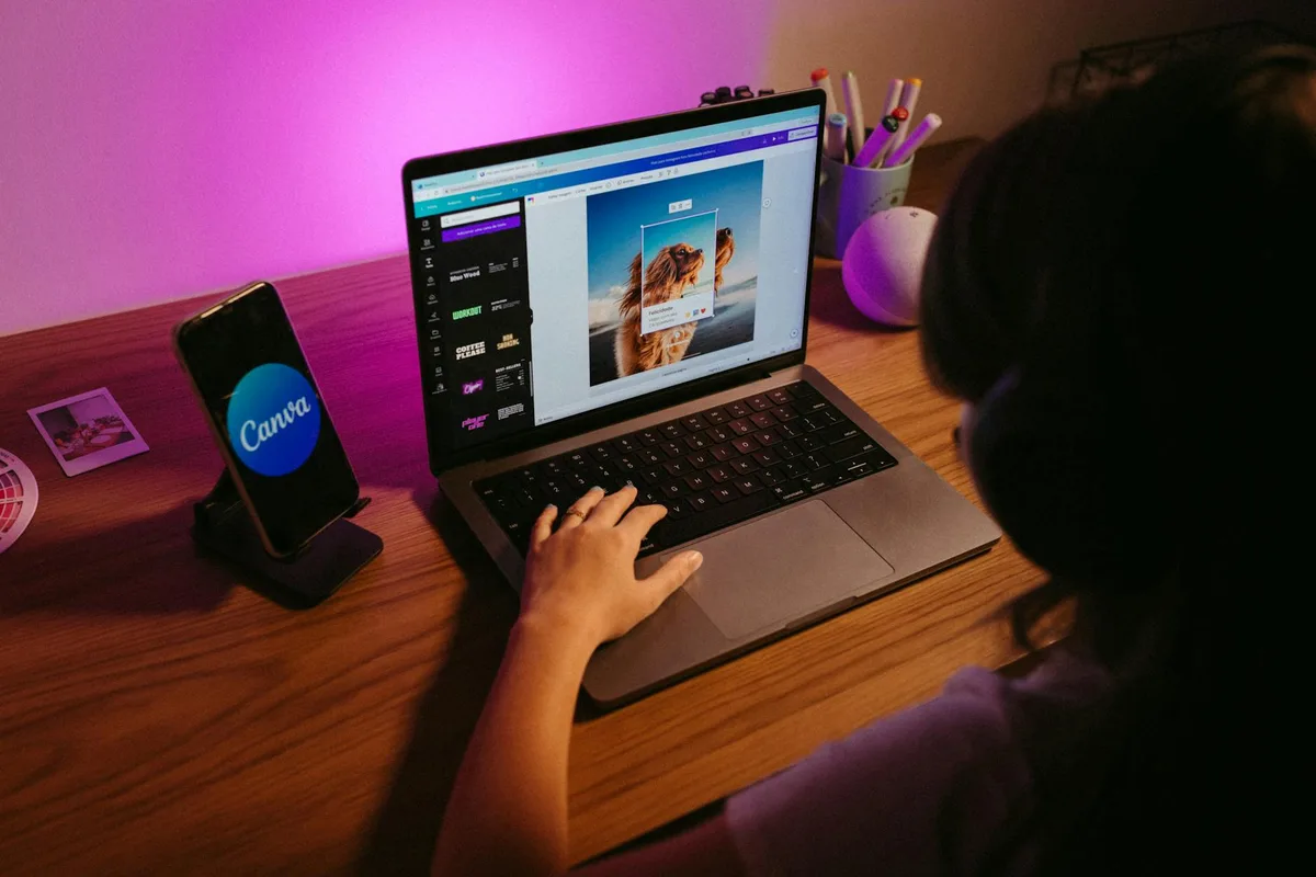 A laptop screen showing the Canva design editor with a checklist lead magnet template open, being customized with navy and coral brand colors