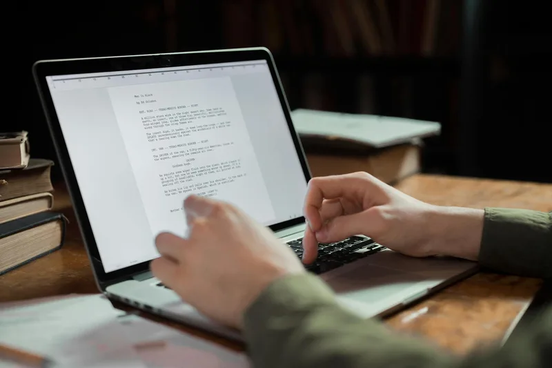 A writer editing AI-generated content on a laptop, refining lead magnet copy to add voice and specific examples before final export