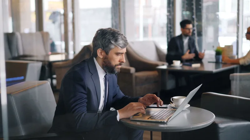 Person working on a laptop reviewing their lead magnet analytics and planning the next iteration of their conversion strategy